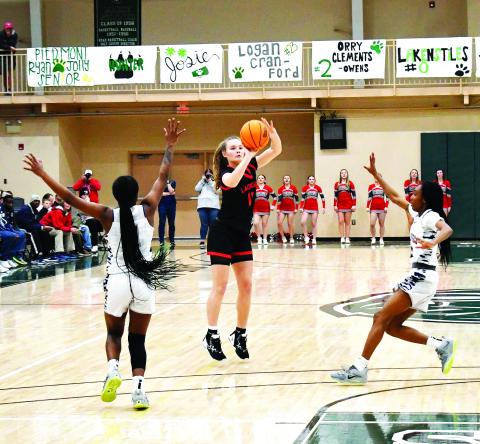 Luke Morey/The Clayton Tribune. RCHS junior Lucy Hood hits a shot as two Elbert defenders rush out to the three-point line. Elbert County won the Region 8 title 61-41 on Friday, Feb. 17. The No. 2 Lady Cats took on Pepperell on Tuesday, Feb. 21, in the first round of the GHSA state playoffs.