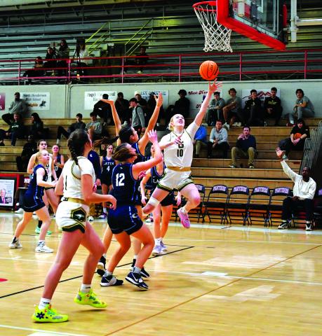 Luke Morey/The Clayton Tribune. Rabun Gap junior Monna Julkunen finishes through contact against Charlotte Latin on Saturday, Feb. 18. Julkunen scored 13 points, helping lead the Lady Eagles to a 63-33 victory, advancing to the NCISAA state semifinal round against Providence Day School on Feb. 21. 