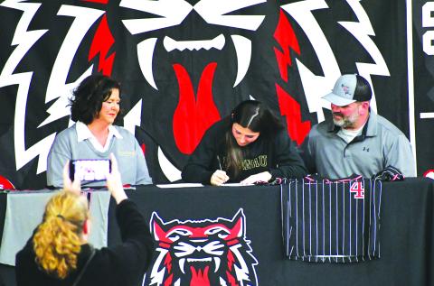 Luke Morey/The Clayton Tribune. Surrounded by parents Kim and Christian Lovell, Rabun County senior Mary Lovell signs her Letter of Intent on Tuesday, Jan. 31. Lovell, who has played softball and basketball at RCHS, will attend Brenau University for softball. In her senior softball season, Lovell hit .451 with five home runs for the Lady Cats.