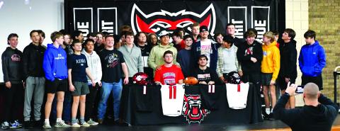 Luke Morey/The Clayton Tribune. Joined by their football teammates, Rabun County seniors Keegan Stover (seated left) and Nicholas Baloga signed to play at the college level on Wednesday, Feb. 1. Stover and Baloga both led Rabun County to a 12-1 record in the senior season.