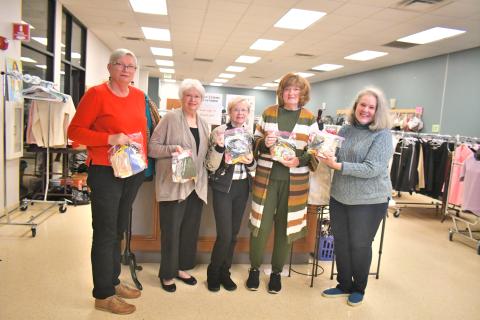 Megan Broome/The Clayton Tribune. Volunteers at First Impressions, a work-need ready clothes closet in Clayton, hold up “Blessing Bags” created by children at Wolffork Baptist Church in Rabun Gap to hand out to homeless people in Rabun County to help serve their needs. Pictured are Regina Sulley; Judy McCracken of Wolffork Baptist Church; Donna Pruitt; Karen Carroll; and Janine Bethel. 