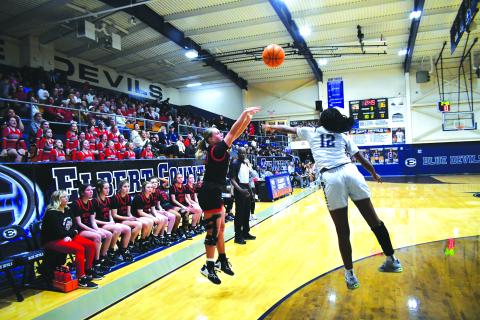 Luke Morey/The Clayton Tribune. RCHS junior Ellie Southards releases a three-point shot Tuesday evening on the road at Elbert County over Lady Blue Devils defender Brenasia Faust. The Lady Cats fell 52-41 in the region showdown.
