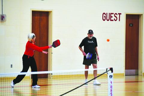 Photography by Tribune staff and Rabun County Recreation Department staff. Rabun Pickleball Club President Larry Walker looks on as his doubles partner Linda Lincoln returns a serve during this month’s Battle of the Paddles. Walker and Lincoln secured the gold medal for the mixed doubles 3.5 skill level at the 70 age bracket. 