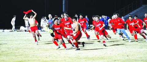 Luke Morey/The Clayton Tribune. With dejected Barrow Arts and Sciences Academy players in the background, the Rabun County Wildcats celebrate a victory in penalties. The game-winning penalty was scored by senior Ezequiel Ramos (pictured center with brother Rodolfo Ramos who is wearing No. 4) on a night where Rabun County honored its seniors. The Lady Cats also picked up a victory over BASA by cruising to a 3-1 win. The Rabun County boys and girls teams only have one more region game until the playoffs begin