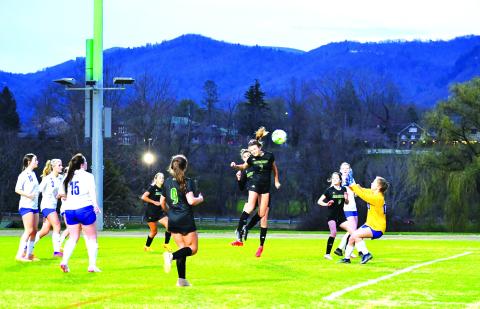 Luke Morey/The Clayton Tribune. Rabun Gap Lady Eagle junior Georgia Mattis heads the ball past the Highlands goalkeeper for the first goal of the night on Wednesday, March 8. Mattis has helped lead the Lady Eagles to a 4-0-1 start by scoring four goals in five games. 