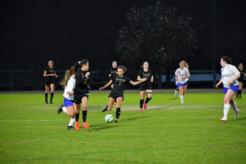 Luke Morey/The Clayton Tribune. Rabun Gap Lady Eagle Georgia Mattis (2) passes the ball ahead to Laea Blakely against Highlands School on Wednesday, March 8. Blakely and Mattis have helped push the Lady Eagles to a 6-0-1 record. 