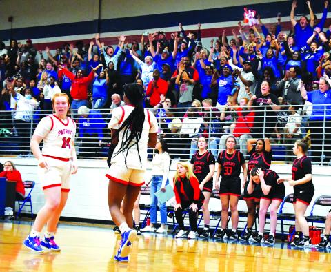 Luke Morey/The Clayton Tribune. With a jubilant Oglethorpe crowd behind them, Rabun County head coach DeeDee Dillard and the Lady Cat bench react to a last second travel call on Friday, Feb. 24. The Lady Cats lost to Oglethorpe County 51-50, ending their season in the Sweet Sixteen.