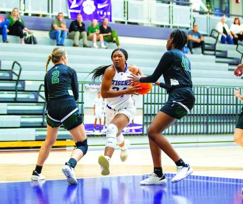 Kerry Gordon/Rome News-Tribune. Darlington's Jy Johnson attacks the paint against Tallulah Falls School defenders Breelyn Wood (2) and Tanisha Seymour in the first round of the GHSA state playoffs in Rome on Feb. 22. Darlington won 57-36 as the visiting Lady Indians saw their season come to a close, finishing with a 7-17 record, led by Region Player of the Year Denika Lightbourne.