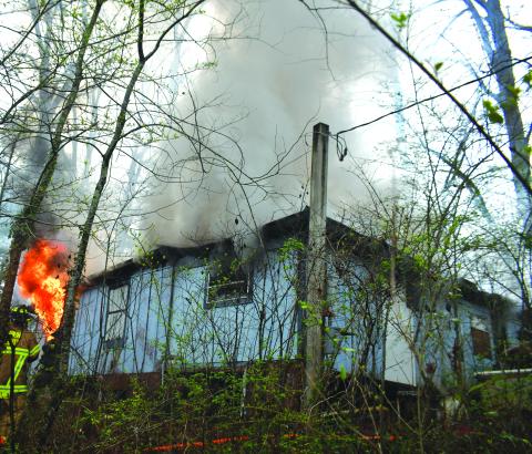Megan Broome/The Clayton Tribune. Rabun County Fire Services deploys defensive and offensive tactics to knock down a structure fire at 338 Turpin Street in Tiger March 2. The structure was determined to be a complete loss. 