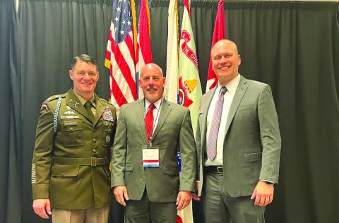 Photo courtesy Roger Glenn. Roger Glenn (center) stands with Lt. Col. Michael Kelvington, professor of military science, and Doug Huber, the current president of The Ohio State Army ROTC Alumni Society, at Glenn’s induction ceremony into the university’s ROTC hall of fame.