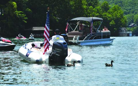 Enoch Autry/The Clayton Tribune. When Independence Day weekend comes in July, a new statewide legislation involving wakeboarding and wakesurfing on Georgia lakes may be enforced if Gov. Brian Kemp signs the bill into law. Here two ducks swim in the waters of Lake Burton last year as the Ski Patriots prepare to continue their miles-long trek around the lake in honor of America.