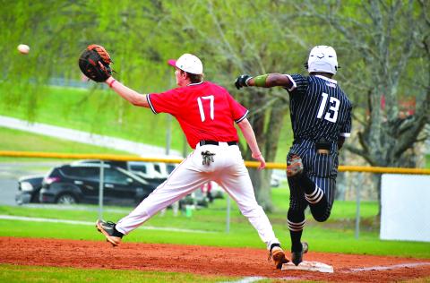 Luke Morey/The Clayton Tribune. Tallulah Falls senior Frankey Moree beats out a throw to Rabun County first baseman Elvis Hunt on Tuesday, April 4. Moree and the Indians have now clinched a playoff berth with six games remaining in the regular season. 
