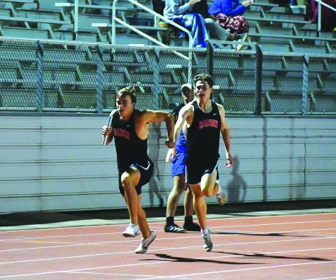 Luke Morey/The Clayton Tribune. Hayden Deslich passes the baton off to Paul Picciotti during the 4X400 on Wednesday, April 19. The relay team of Deslich, Picciotti, Hayden Smith and Willie Goodwyn finished the relay with a time of 3:34.