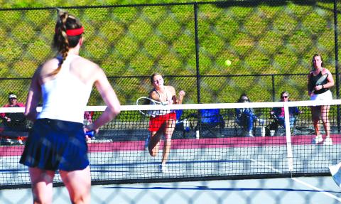 Luke Morey/The Clayton Tribune. RCHS senior Natalie Watson (left) returns a hit against Mt. Pisgah with teammate and fellow senior Allana Jones looking on. Watson and Jones, the No. 1 doubles duo, won against Mt. Pisgah but the Rabun County team fell 3-1 to bow out of the GHSA State playoffs in the Sweet Sixteen. 