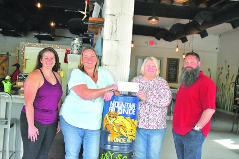 Megan Broome/The Clayton Tribune. Nancy Gribble with Ferst Readers of Rabun County accepts a donation check for $3,075 from nonprofit night held at Currahee Brewing Company on April 6. Pictured are Ara Joyce, Hillary Marshall, Gribble and Scott Mazarky. 