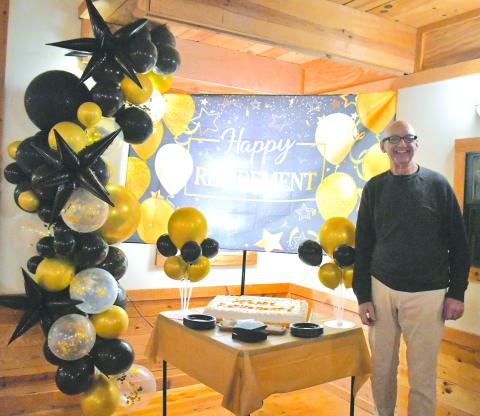 Megan Broome/The Clayton Tribune. Dr. Guy Gober of Tiger Clinic stands in front of his cake that reads “Happy Retirement!” during his retirement party Friday, March 31, after being in Rabun County for 33-and-a-half years. 