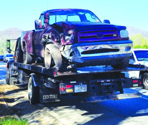 Megan Broome/The Clayton Tribune. This red 2006 Toyota Tundra, driven by a Mountain City man, went off the roadway in Mountain City, striking a power pole and concrete barrier. 
