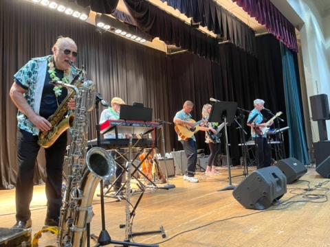 Submitted photo. The band Sweet Charity with guest musician Greg Funkhouser performs at the Clayton Rotary Club Foundation’s Luau fundraising event April 22.