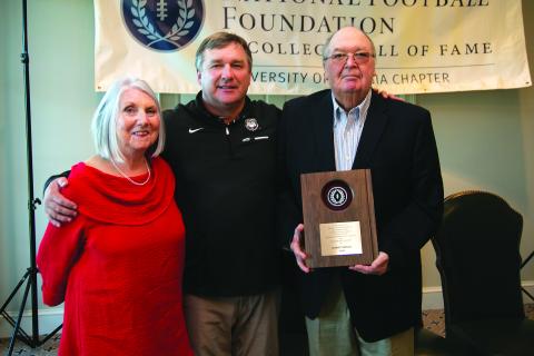 Submitted photo. Standing with his wife Sharon, Sonny Smart (far right) receives the Contribution to Amateur Football Award. A Rabun County resident, Smart is the father of current University of Georgia head football coach Kirby Smart (center). Among his career stops, Smart was the head football coach and athletic director at Rabun County High School.