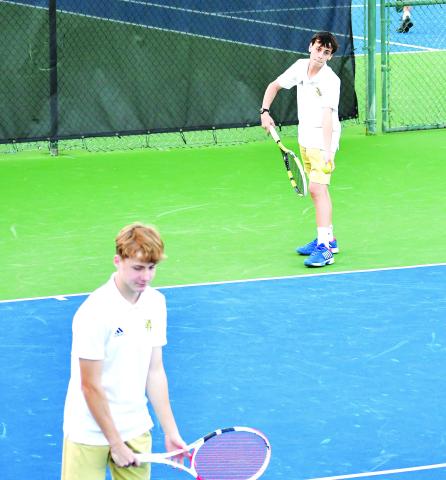 Luke Morey/The Clayton Tribune. Rabun Gap sophomore Pablo Gispert prepares to serve while sophomore tennis teammate Chris Hohmann readies at the net. The Eagles boys tennis team won 5-4 in the first round of the playoffs before losing 5-1 to Charlotte Latin School.