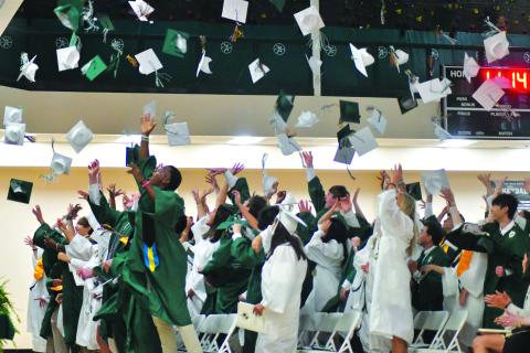 Enoch Autry/The Clayton Tribune. The Class of 2023 toss their caps into the air in celebration of graduating from the Tallulah Falls School.