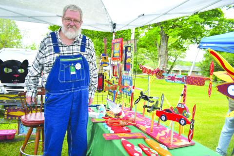 Megan Broome/The Clayton Tribune. Charlie Dingler, organizer of Dinglerfest along with Kip Ramey, showcases his artwork at the inaugural festival Saturday, May 6. Dingler showcased his “Whirligig” creations and his folk art creations. His medium is typically mixed-media and three dimensional. The event featured many exhibitors showcasing their beautiful handmade creations including folk art, pottery, paintings and much more.