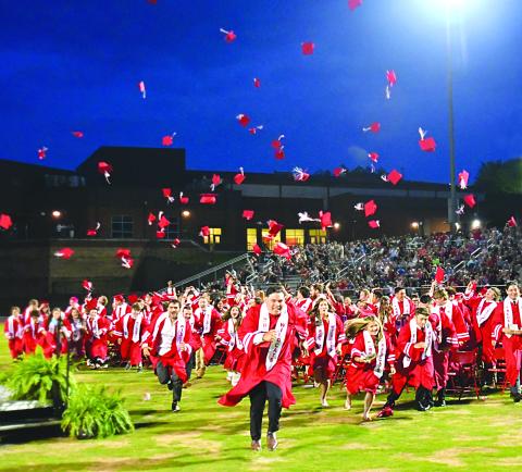 Enoch Autry/The Clayton Tribune. After Rabun County High School Principal Justin Spillers announces the Class of 2023 are graduates, the student body rush to ring the bell at Frank Snyder Memorial Stadium. 