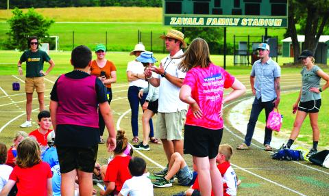 Luke Morey/The Clayton Tribune. Boys lacrosse head coach Ryne Linsley talks to the campers after the Olympics events on Friday, June 16.