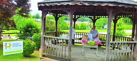 Megan Broome/The Clayton Tribune. Laura Lane with Rabun County Family Connection sets up Happy Helpings during the library summer reading program launch, offering meals to those 18 and under. 