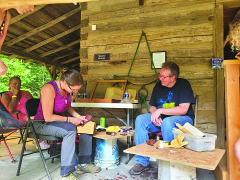 File photo/Megan Broome/The Clayton Tribune. Foxfire’s Kelly Coldren, a fiber artist, demonstrates weaving at the Foxfire Museum in 2022. This year’s event will be June 9 and 10.
