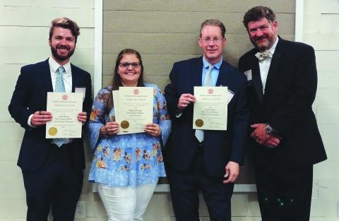 Photo courtesy Conner Horn. Holding their Georgia Press Association awards, The Clayton Tribune staff members Luke Morey, Megan Broome and Enoch Autry stand next to Community Newspapers, Inc., Chairman Alan NeSmith on June 9.