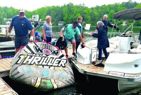 Submitted photo. Volunteers for the LBCA “Clean Up the Lake Day’ event on Friday, May 12, unload a large float found on Lake Burton.