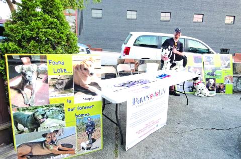 Megan Broome/The Clayton Tribune.  Everett Lampros, public relations, volunteer and adoption coordinator, mans the Rabun Paws 4 Life booth answering questions and providing information about the organization.  