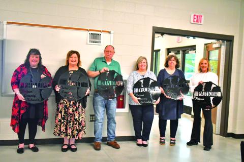 Megan Broome/The Clayton Tribune. Retiring employees at Rabun County Schools were recognized May 18 at the Agri-Science Center and given a gift made by Rabun County students in mechanics class. Pictured are Diane Phillips, RCES teacher (left); Pam Hurt, RCPS music teacher; James Dunham, RCMS custodian; Audrey Decker, RCES nurse; Kelley Curtis, RCES teacher; and Lora Parker, RCES paraprofessional. Not pictured are Memorio Cruz, RCHS custodian; Phil Sidey, RCHS paraprofessional; and Dowana Hopper, bus driver.