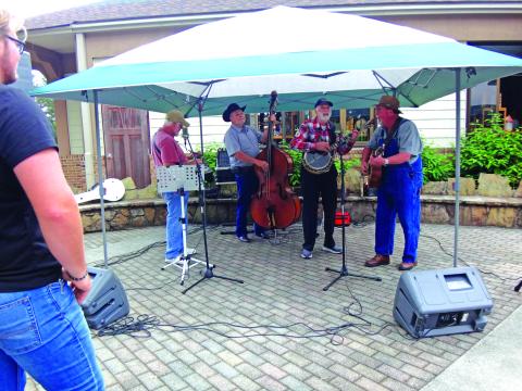 Submitted photo. The Tallulah Falls Band members Kerry Cash, of Mount Airy, on Dobro (from left); Bryan Addis, of Mount Airy, upright bass; Ben Johnson, of Gum Log, banjo; and Stanley Starnes, of Lawrenceville, guitar play at the Tallulah Gorge State Park’s 30th anniversary. The band has been together for 22 years and plays on Saturday nights in the Tallulah Falls city park. 