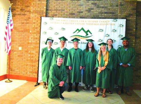 Megan Broome/The Clayton Tribune. Mountain Education Charter High School Class of 2023 graduates include Abbigail Jane Forsythe Hoy, back left; Kain Vuong Tran-Cao; Adrian Mauricio Aguilar; Bryce Cristian Weaver; High Honor Graduate Jessica Kaylee Dale; Destiny Cheyanne Jones; Fernando Silva Yepez; and Braden Daniel Edler. Not pictured is graduate Suzanna “Ana” Irene Garcia. 