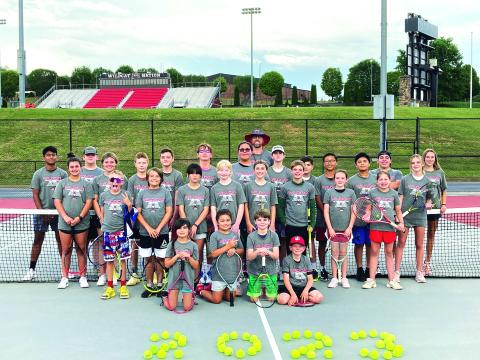 Photo courtesy Bryan Getty. Getty and Wildcat tennis athletes pose with their campers from the Wildcat Tennis Academy