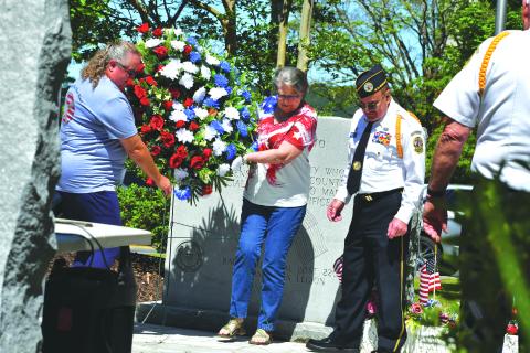 Megan Broome/The Clayton Tribune. Pam Wheeler, founder of the organization Creating Ties That Bind: For Soldiers and Families Wounded By Loss; and Karen Trombley, state coordinator for Quilts of Valor Foundation, place the wreath to honor soldiers who passed at the Memorial Day Ceremony held at the Rabun County Courthouse Monday. Also pictured are Chaplain Dr. Kenneth Franklin, DAV. CH. 15 and SVCDR. DAV. Ch. 15 Doug Wayne in the foreground.