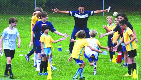 Enoch Autry/The Clayton Tribune. Claudio Lima waits for his campers to come in for a hug at the end of the camp held at Rabun County Recreation Department from June 19-23. 