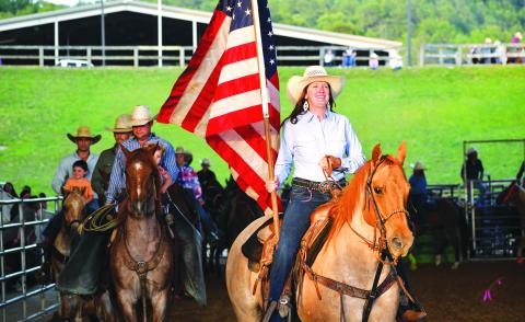 Luke Morey/The Clayton Tribune. Bar W Rodeo Company started the night with a procession led by the American Flag. 