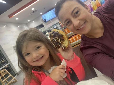 Submitted. Locals Amber Owens and 5-year-old Rylee Owens are the first customers to enjoy doughnuts just before 5 a.m. at the new Dunkin’ Donuts in Clayton on opening day Thursday, July 13. 