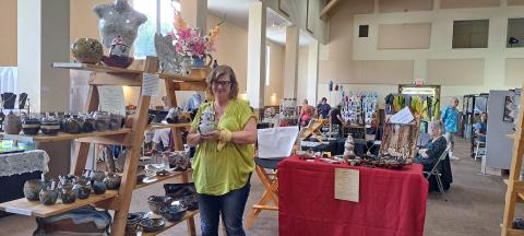 Megan Broome/The Clayton Tribune. Amy Lovelady Strickland with Lovelady Creations showcases her pottery at the Painted Fern Art Festival in Clayton last weekend. Strickland took home the Best in Show Peoples’ Choice Award for her pottery. 