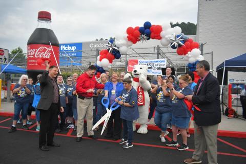 Megan Broome/The Clayton Tribune. Forward Rabun/Rabun County Chamber of Commerce celebrates with community members as they cut the ribbon on the newly renovated Walmart Supercenter in Clayton. 