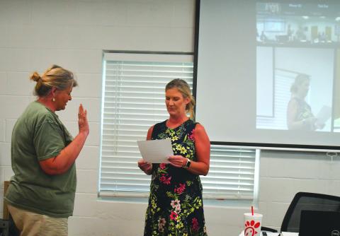 Megan Broome/The Clayton Tribune. Tallulah Falls Town Clerk Linda Lapeyrouse gives newly appointed Council Member Cissy Henry the oath of office as she is sworn in during the town council meeting Aug. 16. Henry fills the seat left vacant by Tom Tilley until a Nov. 7 special election.