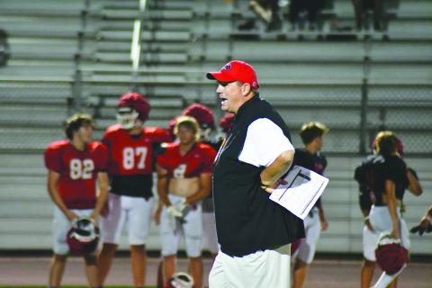 Enoch Autry/The Clayton Tribune. RCHS head coach Michael Davis watches his Wildcats during Midnight Madness practice on July 31. The Wildcats scrimmage Bowdon Friday.