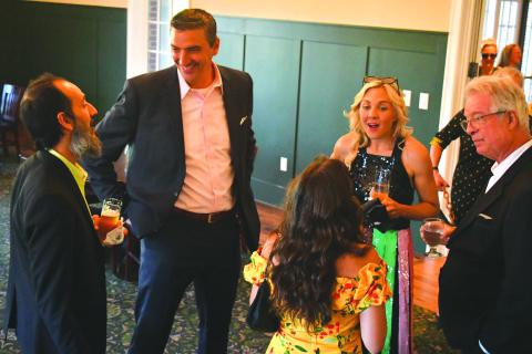 Enoch Autry/The Clayton Tribune. Mehran Ebadolahi (from left) talks with Rabun Gap-Nacoochee Head of School Jeff Miles as Andrea Sorgeloos and Keith Sorgeloos talk to guests at the Green & Gold Gala in the Woodruff Dining Hall.