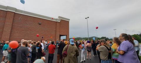 Megan Broome/The Clayton Tribune. Rabun County community members held a Candlelight Vigil at the north end of Ingles in Clayton Aug. 7 to honor the life of Rabun Gap man Frank Hanrahan, who suddenly died in a motor vehicle crash July 31. Hanrahan worked at the Clayton Ingles for 23 years and those honoring him lit candles, played “Amazing Grace” and released 23 balloons representing his 23 years at the business. 
