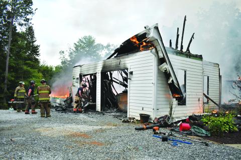 Megan Horn/The Clayton Tribune. Rabun County firefighters battle a structure fire on Sidetrack Lane on Aug. 27. 