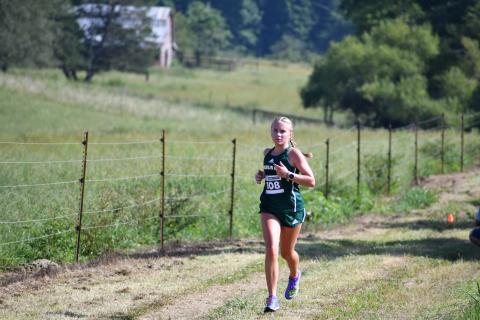 Wade Cheek/The Clayton Tribune. Rabun Gap freshman Bailey Brackett races to the finish line to take first place in the girls race on Aug. 31.