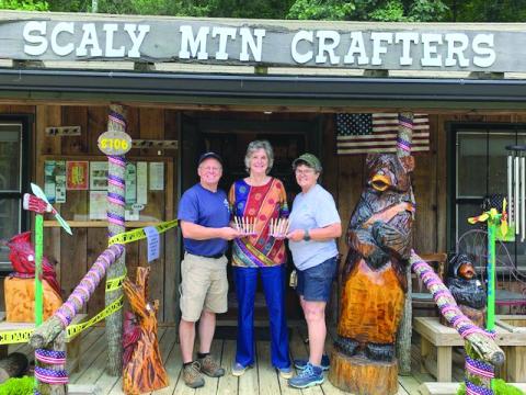 Submitted photo. Michelle and Darren Gillett of Scaly Mountain Crafters (Pens with a Purpose), present a donation to Dee Vollmer with the Scaly Mountain Women’s Club. Below:  A group of the donated pens.